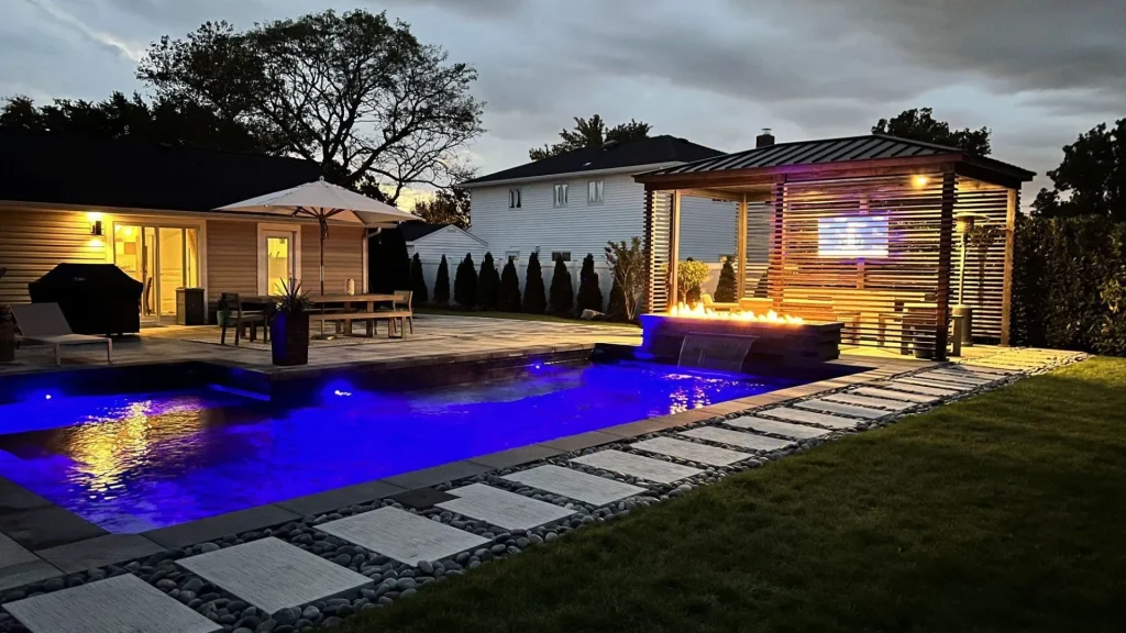 Custom landscape design in Pinellas County showing modern backyard with patio, plants, and lighting